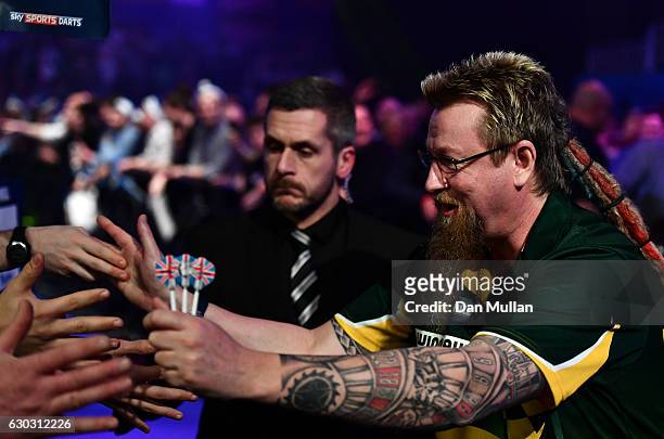Simon Whitlock of Australia makes his way to the stage during the first round match against Dragutin Horvat of Germany on day six of the 2017 William...