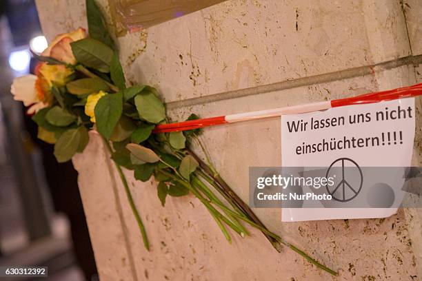 Flowers and a solidarity message reading 'we don't let them intimidate us' in a makeshift memorial close to the Kaiser-Wilhelm-Gedaechtniskirche are...