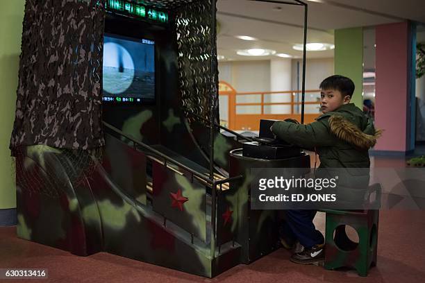 Photo taken on November 26, 2016 shows a child playing a tank-themed computer game at the 'Sci-Tech complex' in Pyongyang. Opened earlier this year,...