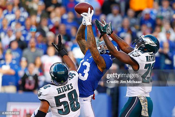 Jaylen Watkins and Jordan Hicks of the Philadelphia Eagles defend against Odell Beckham of the New York Giants on November 6, 2016 at MetLife Stadium...