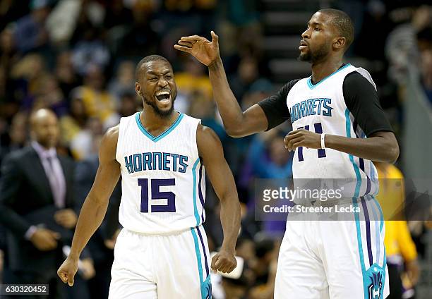 Teammates Kemba Walker and Michael Kidd-Gilchrist of the Charlotte Hornets react after play during their game against the Los Angeles Lakers at...