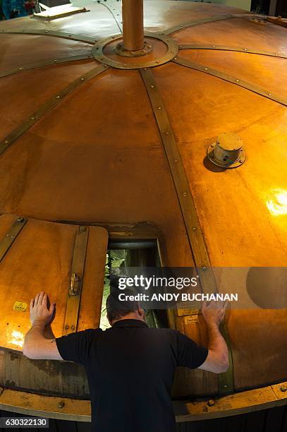 Mashman Stuart McIntosh operates the Mash Tun at the Auchentoshan Distillery, a Single Malt whisky distillery, on the outskirts of Glasgow on...