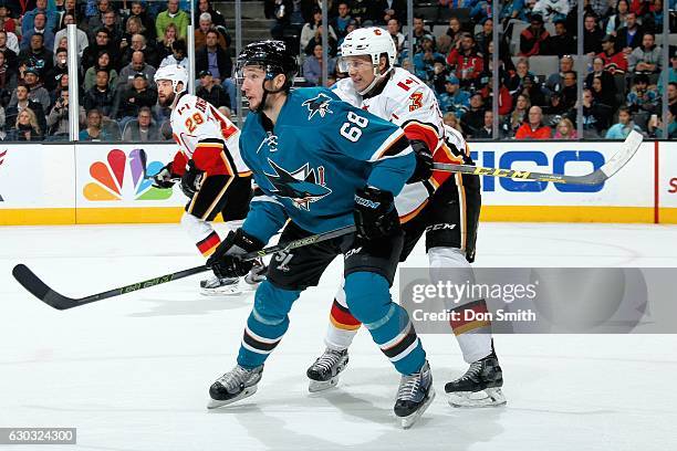 Melker Karlsson of the San Jose Sharks and Jyrki Jokipakka of the Calgary Flames look during a NHL game at SAP Center at San Jose on December 20,...