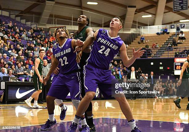 University of Portland sophomore guard Jazz Johnson and University of Portland junior forward Gabe Taylor fill the lane to block out Portland State...