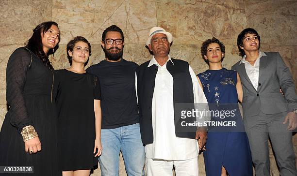 Indian Bollywood ctor Aamir Khan with cast members Fatima Sana Shaikh, , Sanya Malhotra and Indian amateur wrestler and Olympic coach Mahavir Singh...