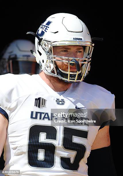 Utah State Aggies defensive lineman Austin Albrecht heads for the field before a game against the USC Trojans played at the Los Angeles Memorial...