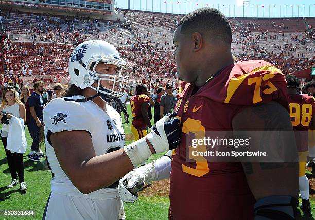 Utah State Aggies offensive lineman Dalton Forsyth with USC Trojans defensive tackle Zach Banner after the Trojans defeated the Aggies 45 to 7 in a...