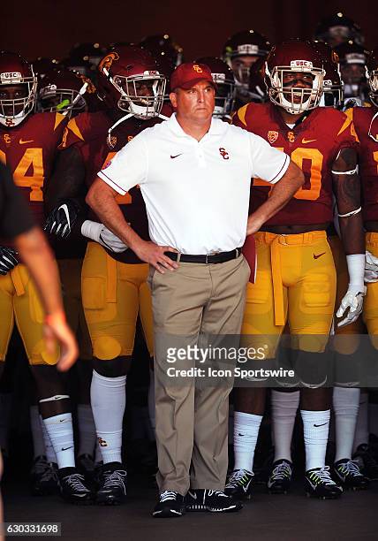 Trojans head coach Clay Helton waits to lead the Trojans onto the field before the start of a game against the Utah State Aggies played at the Los...
