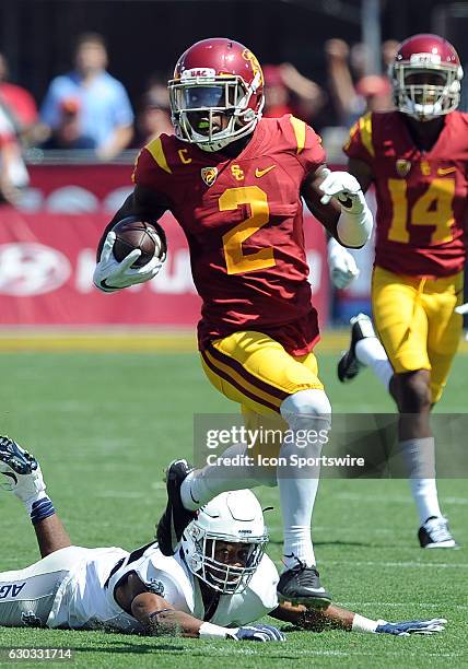 Trojans kick returner Adoree Jackson avoids the tackle of Utah State Aggies cornerback Kevin Ogwu and returns a punt for a touchdown in the third...