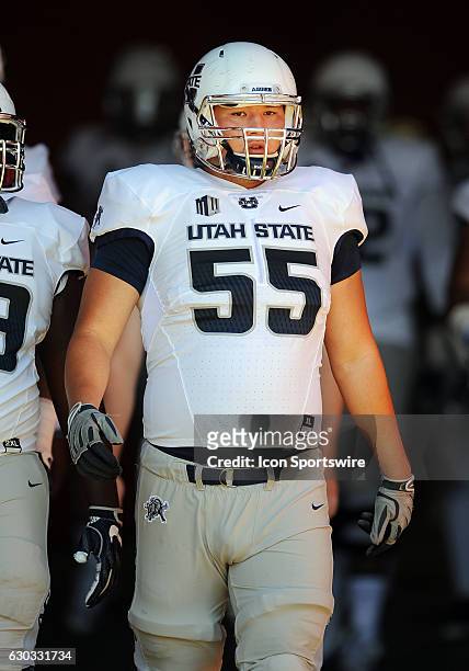 Utah State Aggies offensive lineman Adrew Chen heads for the field before a game against the USC Trojans played at the Los Angeles Memorial Coliseum...