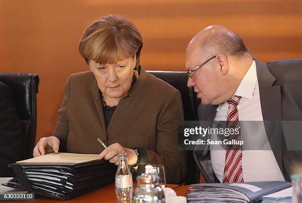 German Chancellor Angela Merkel and Minister of the Chancellery Peter Altmeier arrive for the weekly government cabinet meeting on December 21, 2016...