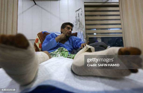 Wounded Iraqi man who was injured during the ongoing fighting between Iraqi forces and jihadists of the Islamic State group in Mosul, receives...