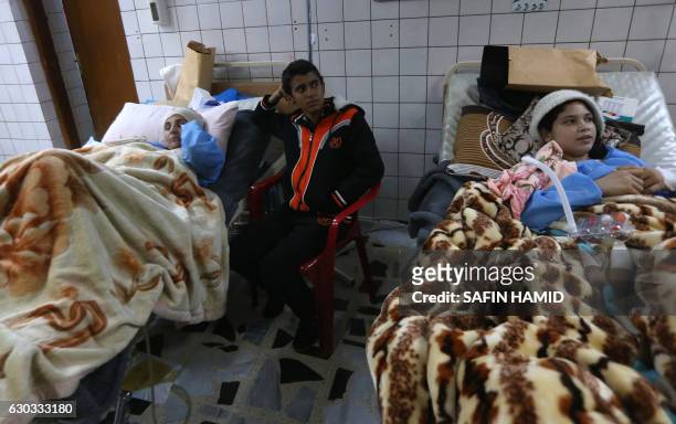 Wounded Iraqis who were injured during the ongoing fighting between Iraqi forces and jihadists of the Islamic State group in Mosul, receives medical...