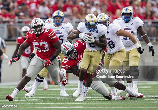 Ohio State Buckeyes defensive tackle Robert Landers makes the hit on Tulsa Golden Hurricane wide receiver Keevan Lucas during the game between the...