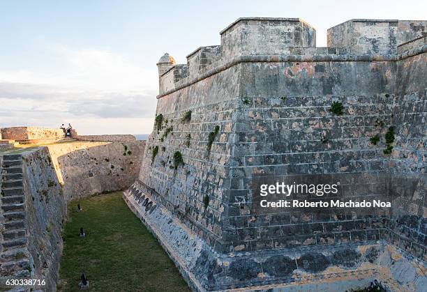 Saint Peter of the Rock castle. Stone steps lead up to a perimeter stone wall with a stone fortification. El Morro de Santiago de Cuba is a Unesco...