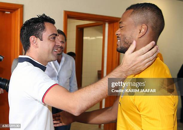 Juventus FC's france player Patrice Evra greets former Barcelona player Xavi Hernandez who is now playing for Qatar's al-Sadd club, during a Juventus...