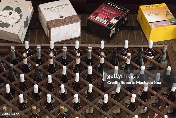 Cuban gastronomy: Wine bottles standing in the shelf in a local Cuban restaurant in Camaguey.