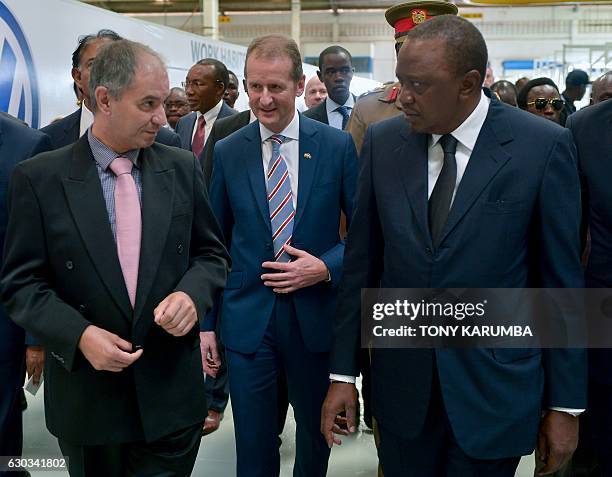 Kenyan President Uhuru Kenyatta , flanked by Volkswagen Brand CEO Herbert Diess , visits the newly opened assembly line of the Polo Vivo hatch-back...