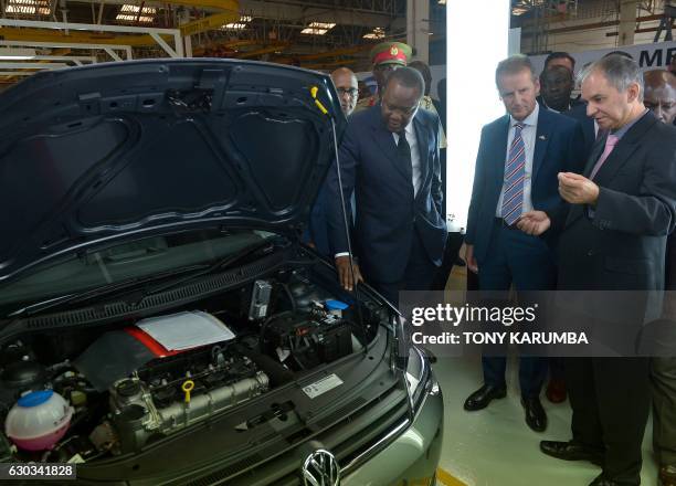 Kenyan President Uhuru Kenyatta , flanked by Volkswagen Brand CEO Herbert Diess , visits the newly opened assembly line of the Polo Vivo hatch-back...