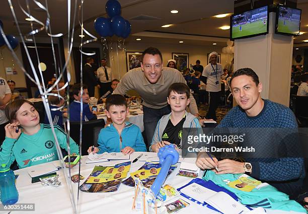 John Terry and Nemanja Matic pose with young Chelsea fans as they attend the club's children's Christmas party at Stamford Bridge on December 21,...