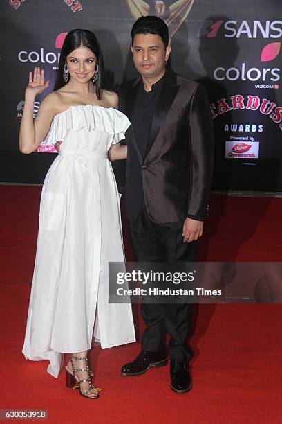 Bollywood filmmaker Bhushan Kumar along with his wife Divya Khosla Kumar poses on red carpet for shutterbugs during the Sansui Colors Stardust Awards...