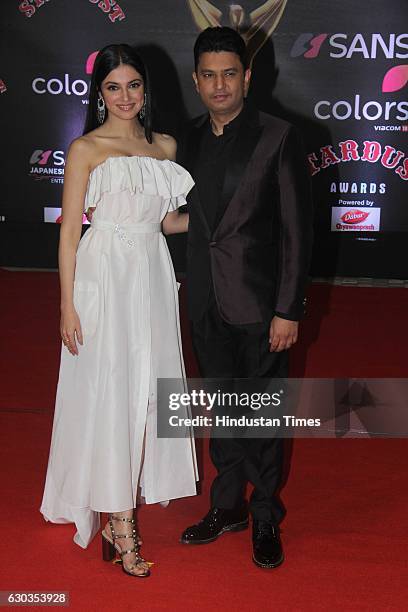 Bollywood filmmaker Bhushan Kumar along with his wife Divya Khosla Kumar poses on red carpet for shutterbugs during the Sansui Colors Stardust Awards...