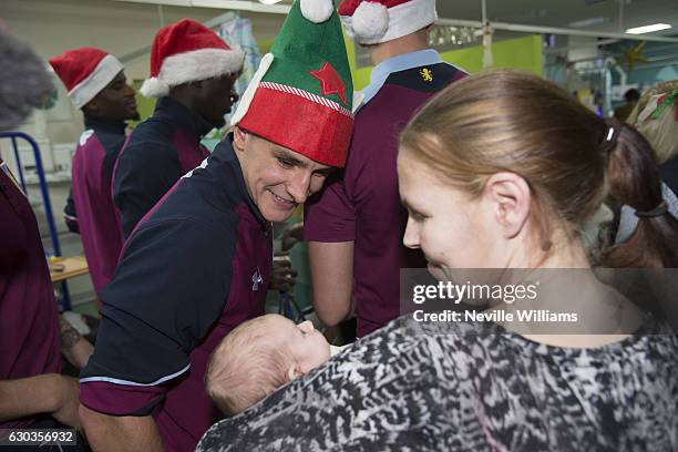 Ashley Westwood of Aston Villa poses for a picture with a child during the club's annual visit to the Children's Hospital at Birmingham City Centre...