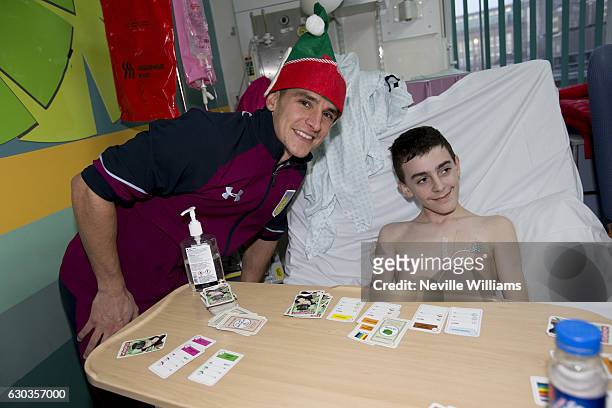 Ashley Westwood of Aston Villa poses for a picture with a child during the club's annual visit to the Children's Hospital at Birmingham City Centre...