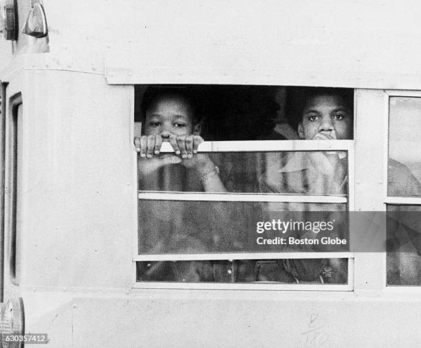 Two students wait on a school bus before being admitted to South Boston High School in Boston on Jan. 8, 1975. An initiative to desegregate Boston...