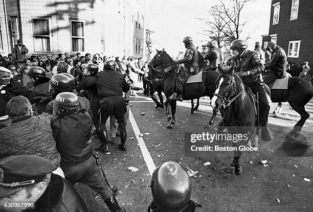 Mounted police officers try to control the crowd after a riot broke out outside South Boston High School on Dec. 11, 1974. The clash between police...