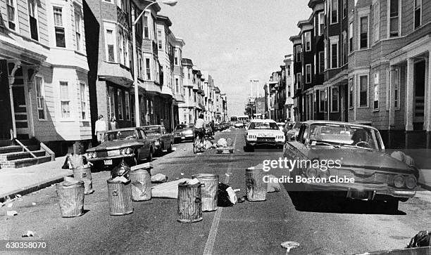 Trash cans and litter cover L Street in South Boston after a protest, Sept. 16, 1974. An initiative to desegregate Boston Public Schools was...