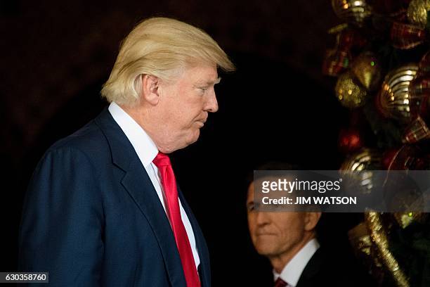 President-elect Donald Trump stands with Trump National Security Adviser Lt. General Michael Flynn at Mar-a-Lago in Palm Beach, Florida, where he is...