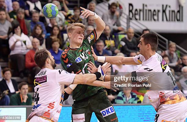 Tim Kneule of Frisch Auf Goeppingen, Christoph Reissky of Fuechse Berlin and Zarko Sesum of Frisch Auf Goeppingen during the game between Fuechse...