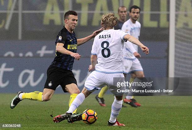 Ivan Perisic of FC Internazionale competes for the ball with Dusan Basta of SS Lazio during the Serie A match between FC Internazionale and SS Lazio...