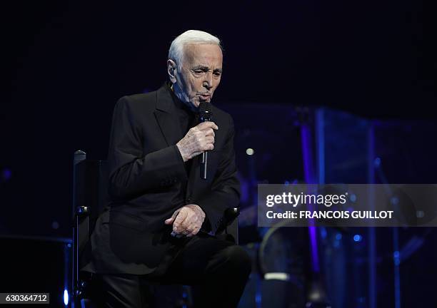 French-Armenian singer Charles Aznavour performs during a concert at the Palais des Sports in Paris on December 21, 2016. / AFP / François GUILLOT