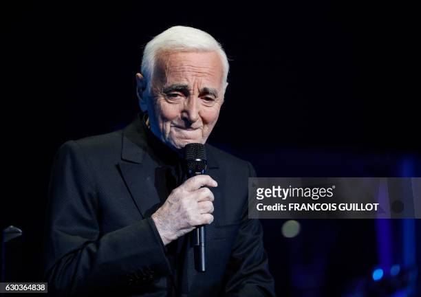 French-Armenian singer Charles Aznavour performs during a concert at the Palais des Sports in Paris on December 21, 2016.