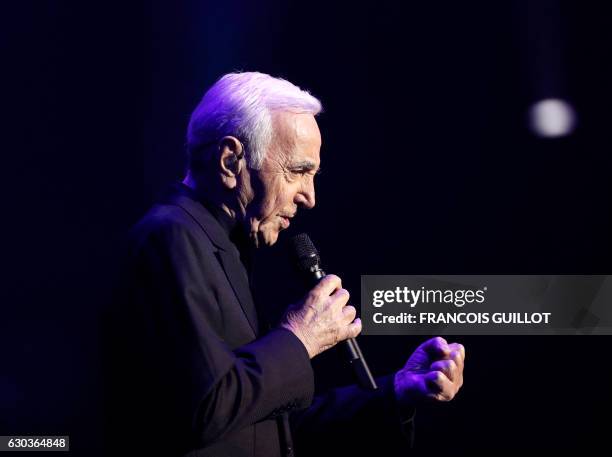 French-Armenian singer Charles Aznavour performs during a concert at the Palais des Sports in Paris on December 21, 2016.