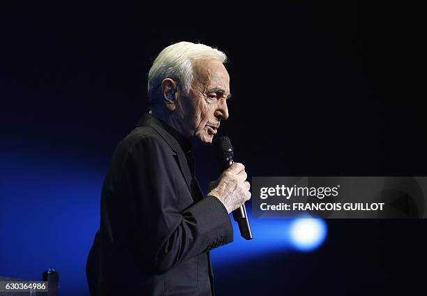 French-Armenian singer Charles Aznavour performs during a concert at the Palais des Sports in Paris on December 21, 2016. / AFP / François GUILLOT