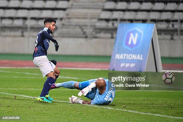 Saifeddine Alami Bazza of Paris FC beats goalkeeper Jeffrey Baltus of CA Bastia to score the only goal of the game during the National match between...