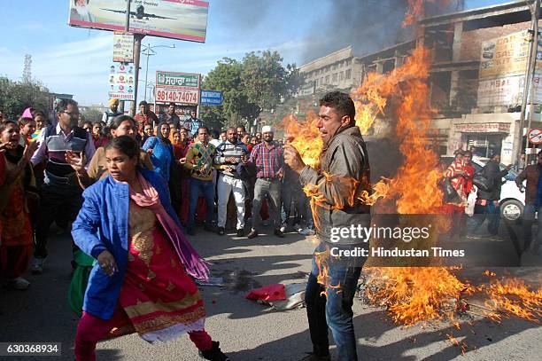 Protester caught in accidental fire during burning the effigy of Punjab government at Fauji Chowk on December 21, 2016 in Bathinda, India. The...