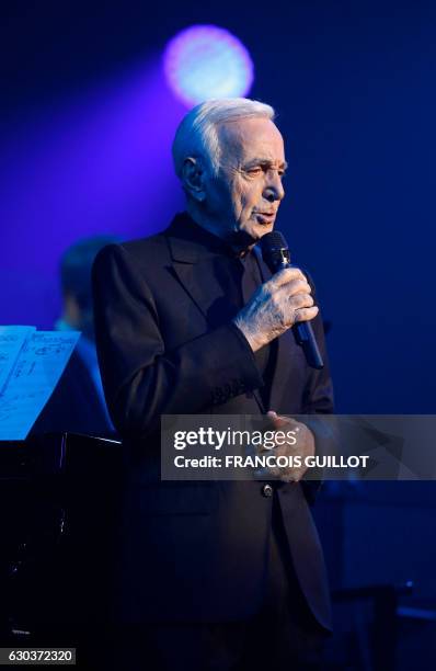 French-Armenian singer Charles Aznavour performs during a concert at the Palais des Sports in Paris on December 21, 2016.