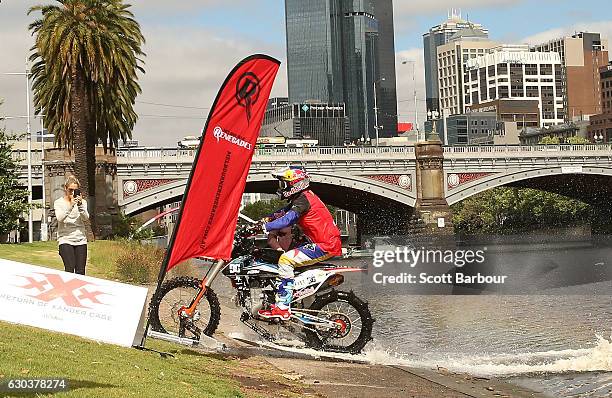 Australian FMX rider Robbie Maddison rides his motorbike along the surface of the Yarra River on December 22, 2016 in Melbourne, Australia. The...