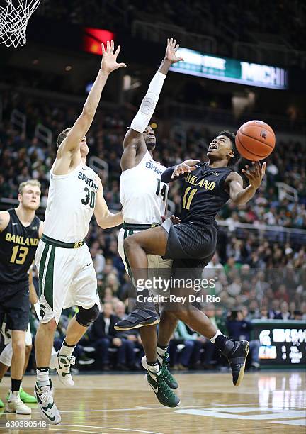 Brailen Neely of the Oakland Golden Grizzlies drives to the basket against Eron Harris of the Michigan State Spartans in the second half at the...