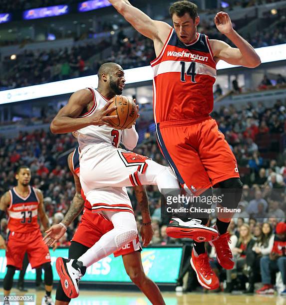 Chicago Bulls guard Dwyane Wade goes to the basket against Washington Wizards forward Jason Smith during the first half on Wednesday, Dec 21, 2016 at...