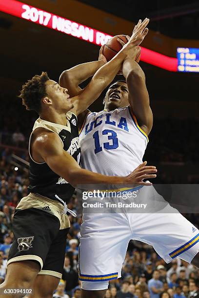 Bryce Moore of the Western Michigan Broncos and Ike Anigbogu of the UCLA Bruins battle for the ball during the second half of their game at Pauley...