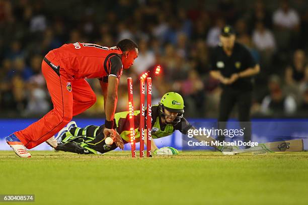 Dwayne Bravo of the Renegades runs out Jake Doran of the Thunder during the Big Bash League match between the Melbourne Renegades and Sydney Thunder...