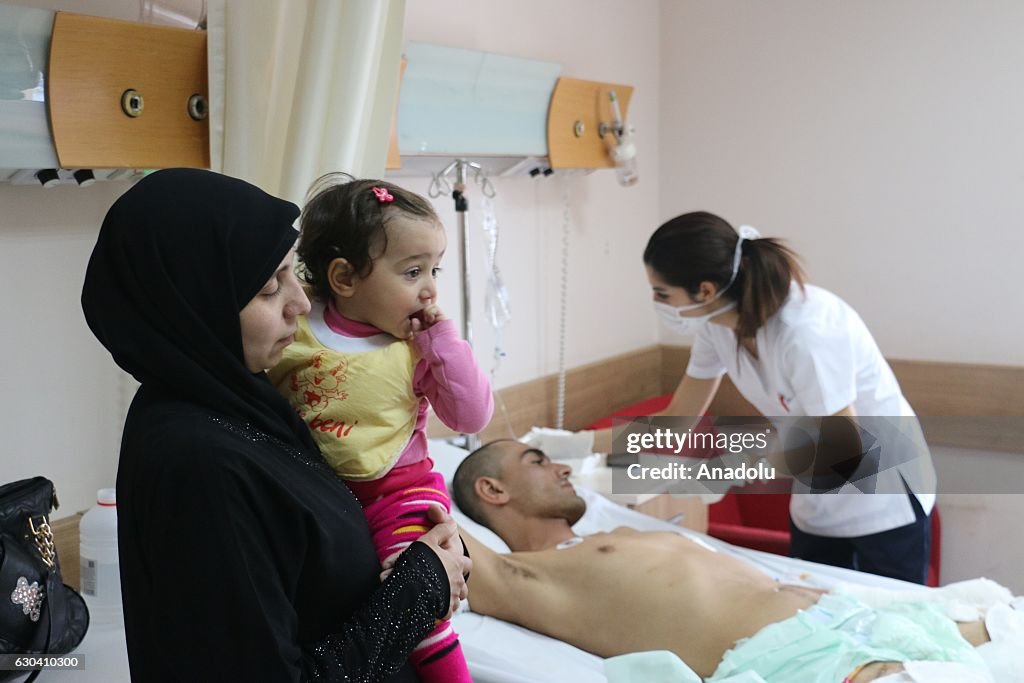 Mustafa Rashida Wounded Syrian Mustafa Rashid receives treatment as his wife Leyla ...