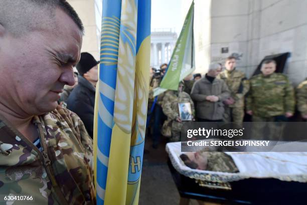 People pay their respects at the coffin of late Volodymyr Andreshkiv, serviceman of volunteer battalion "Kievan Rus" and activist of the Maidan...