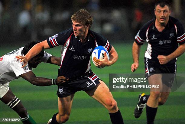 Hong Kong player Mark Wright tries to evade a Sri Lankan player during a Rugby World Cup 2007 qualifier match between Hong Kong and Sri Lanka in Hong...