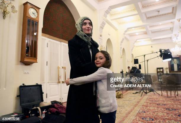 Syrian girl Bana al-Abed , known as Aleppo's tweeting girl, hugs her mother Fatemah during an interview in Ankara, Turkey, on December 22, 2016. The...